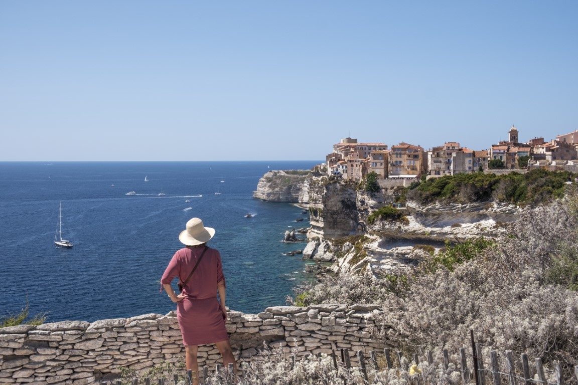 Woman taking in the view at a coastal town