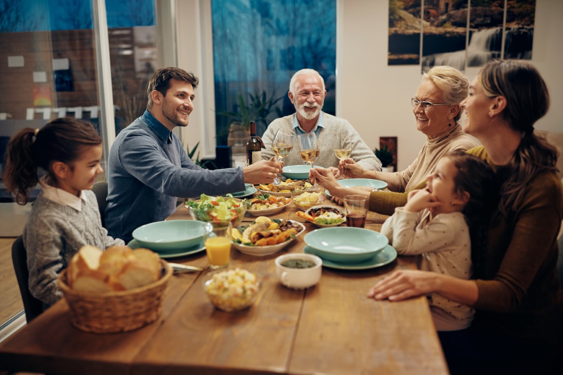 Multi-generational family enjoying dinner together