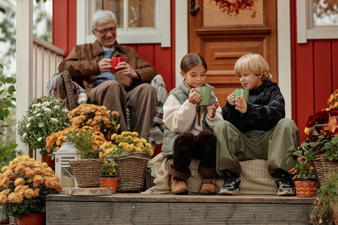 Grandfather enjoying time with grandchildren on the porch